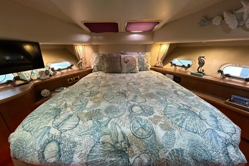 Slide: The Image of Luxurious bedroom in 1999 Bayliner 5788 Pilot House Motoryacht with nautical decor. - 45