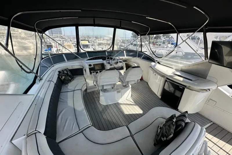 Slide: The Image of 1999 Bayliner 5788 Pilot House Motoryacht interior with seating, helm, and panoramic windows. - 49