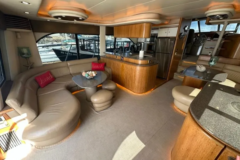 Slide: The Image of Luxurious interior of 1999 Bayliner 5788 Pilot House Motoryacht with elegant seating and modern kitchen. - 5