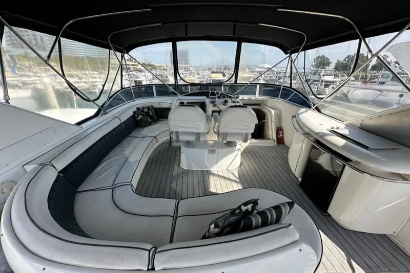 Slide: The Image of 1999 Bayliner 5788 Pilot House Motoryacht interior with seating, helm, and panoramic windows. - 52
