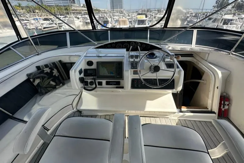 Slide: The Image of 1999 Bayliner 5788 Pilot House Motoryacht helm with steering wheel and navigation equipment. - 53