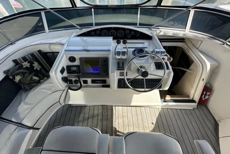 Slide: The Image of 1999 Bayliner 5788 Pilot House Motoryacht helm with navigation equipment and seating area. - 54