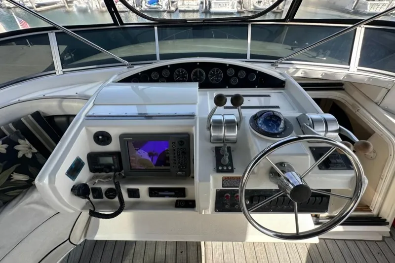 Slide: The Image of 1999 Bayliner 5788 Pilot House Motoryacht helm with navigation equipment and steering wheel. - 55