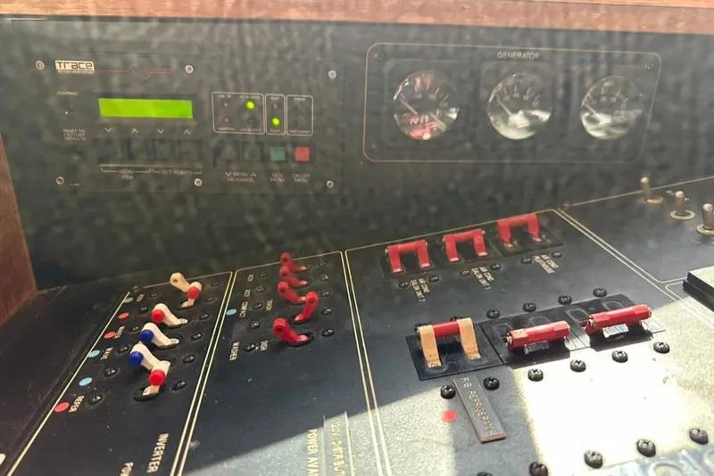 Slide: The Image of Control panel of a 1999 Bayliner 5788 Pilot House Motoryacht, featuring switches and gauges. - 60