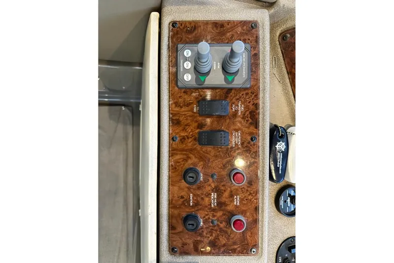 Slide: The Image of Control panel of a 1999 Bayliner 5788 Pilot House Motoryacht with switches and joysticks. - 61