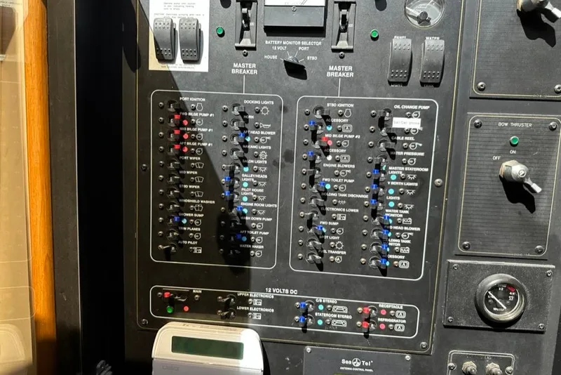 Slide: The Image of Control panel of a 1999 Bayliner 5788 Pilot House Motoryacht, featuring various switches and gauges. - 64