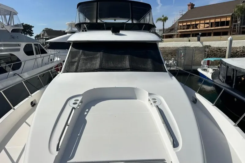 Slide: The Image of 1999 Bayliner 5788 Pilot House Motoryacht docked at marina, front view. - 66