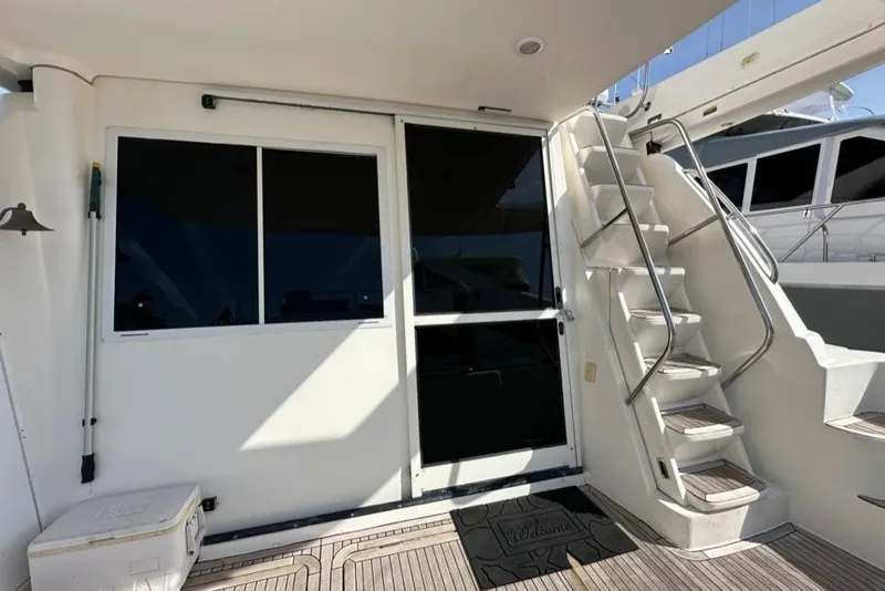 Slide: The Image of 1999 Bayliner 5788 Pilot House Motoryacht deck with stairs and sliding door. - 68