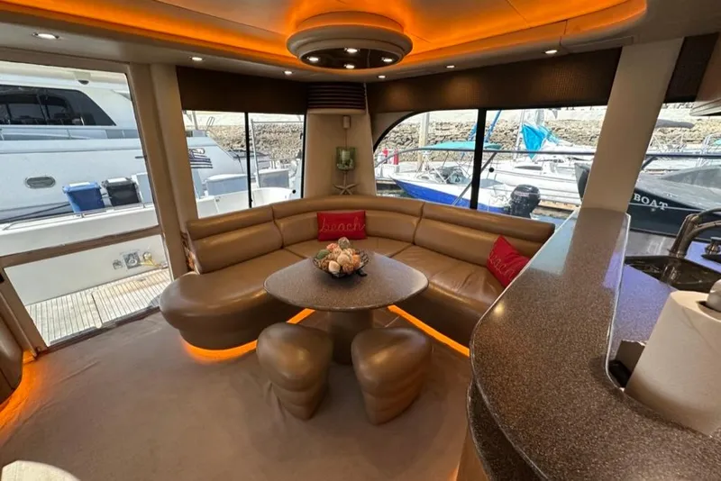Slide: The Image of Luxurious interior of 1999 Bayliner 5788 Pilot House Motoryacht with elegant seating and ambient lighting. - 7