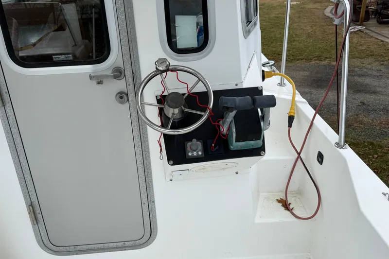 Slide: The Image of Steering console of a 2005 Osprey 28 Long Cabin boat with controls and wiring. - 4
