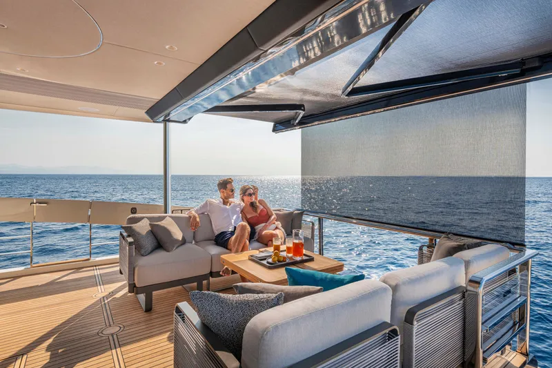 Slide: The Image of Couple relaxing on Absolute 70 N yacht, enjoying ocean view, 2026 model. - 13
