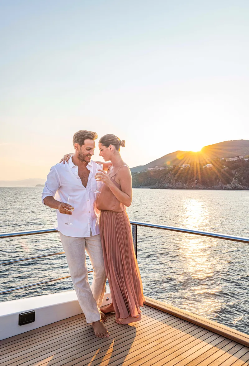 Slide: The Image of Couple enjoying sunset on Absolute 70 N yacht, 2026 model, with scenic ocean view. - 19