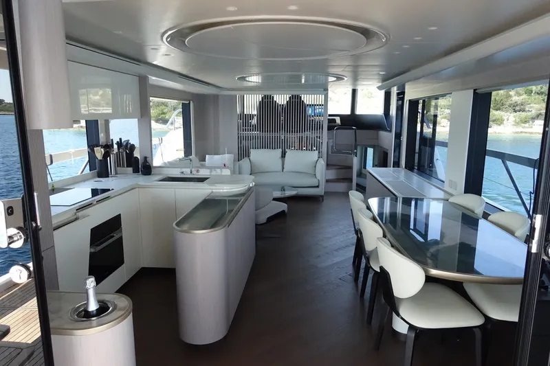 Slide: The Image of Luxurious interior of 2026 Absolute Navetta 70 yacht with modern kitchen and dining area. - 18