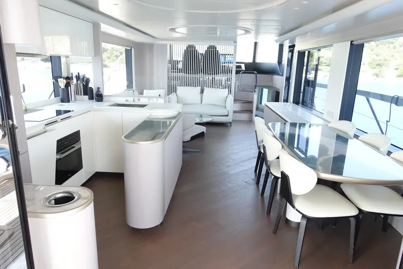 Slide: The Image of Luxurious interior of 2026 Absolute Navetta 70 yacht with modern kitchen and dining area. - 15