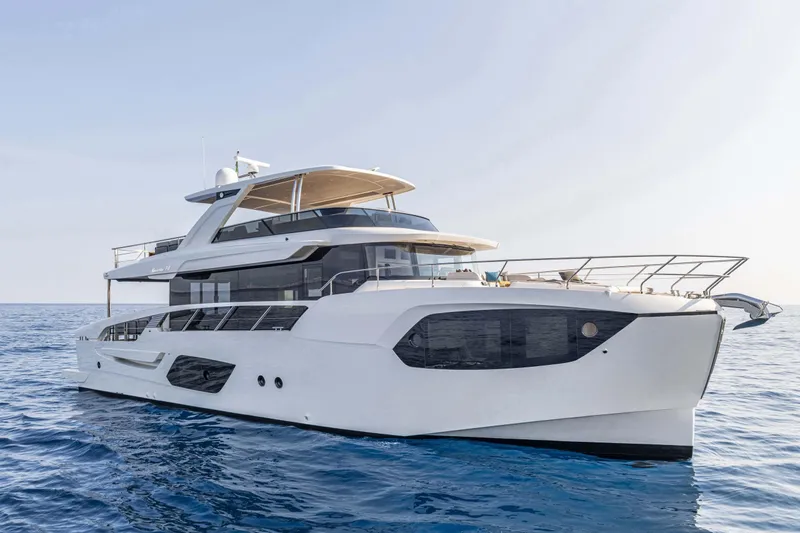 Slide: The Image of Luxury Absolute 70 N yacht on serene blue waters, 2026 model, showcasing sleek design. - 2