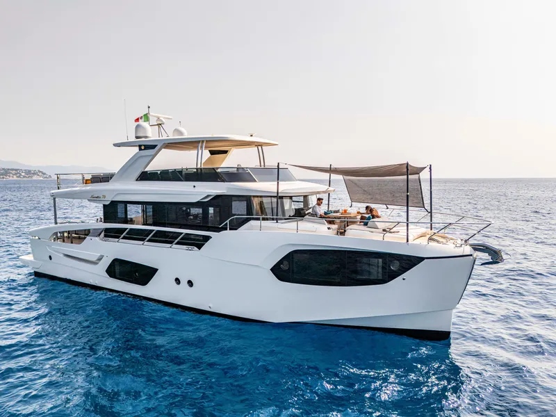 Slide: The Image of Luxury Absolute 70 N yacht on serene blue waters, 2026 model, showcasing elegant design. - 4