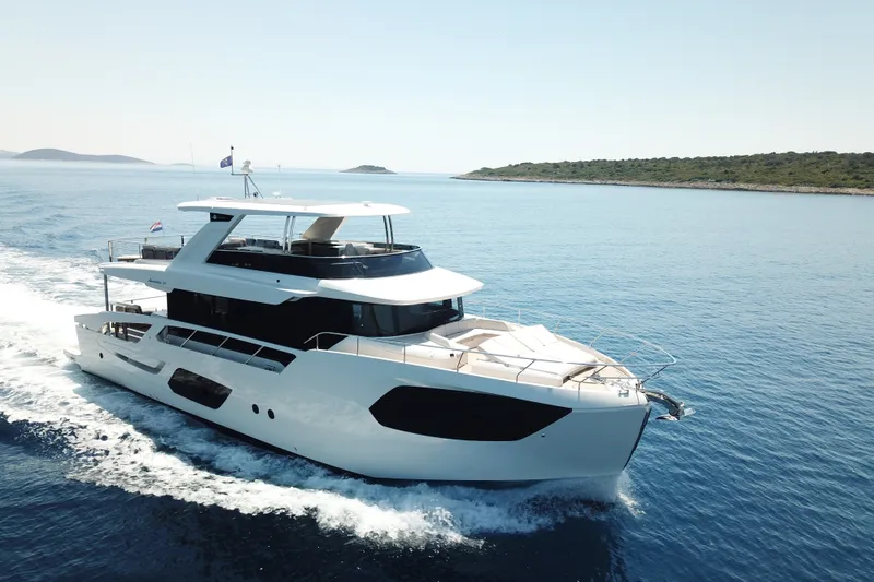 Slide: The Image of Luxury yacht Absolute Navetta 70 cruising on serene blue waters, 2026 model. - 2