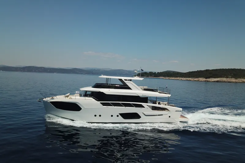 Slide: The Image of 2026 Absolute Navetta 70 yacht cruising on serene blue waters under a clear sky. - 3
