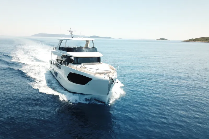 Slide: The Image of 2026 Absolute Navetta 70 yacht cruising on open sea under clear skies. - 4