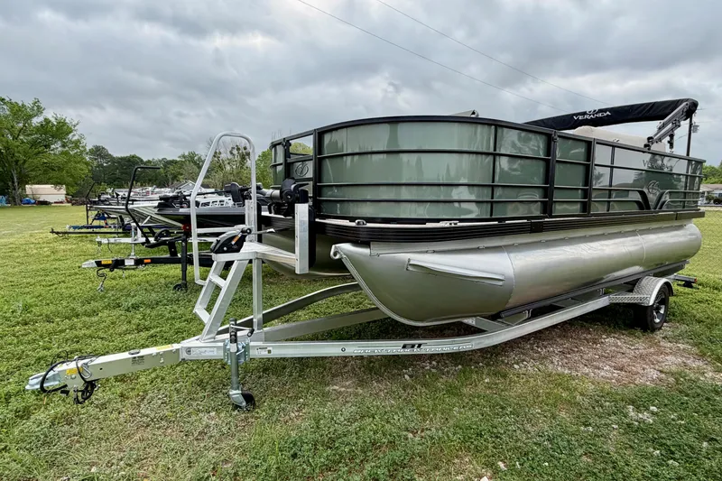 Slide: The Image of 2026 Veranda Vista 18VF4 pontoon boat on trailer, parked on grassy field. - 2