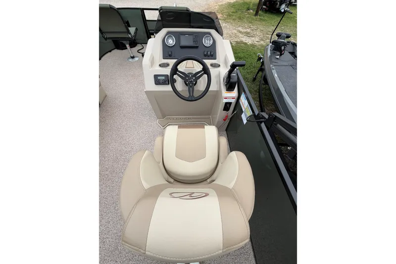 Slide: The Image of 2026 Veranda Vista 18VF4 boat interior with steering console and beige seating. - 7