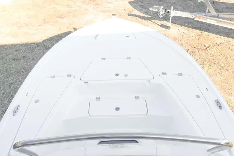 Slide: The Image of 2026 Tidewater 2110 Bay Max boat deck with storage compartments and railing. - 12