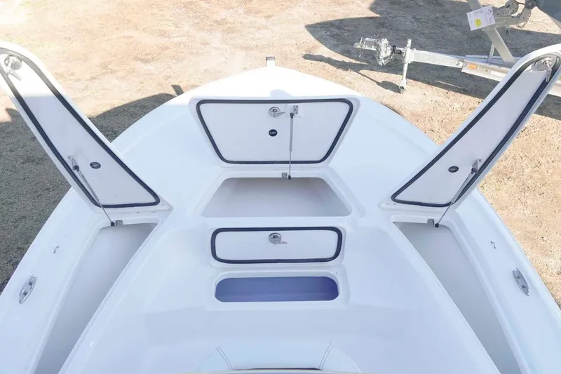 Slide: The Image of 2026 Tidewater 2110 Bay Max boat with open storage compartments on deck. - 13