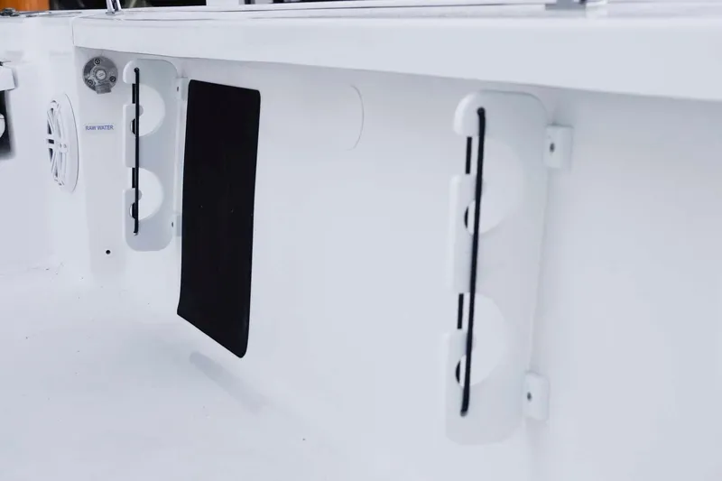 Slide: The Image of Interior view of 2026 Tidewater 2110 Bay Max boat, featuring storage compartments and raw water access. - 14