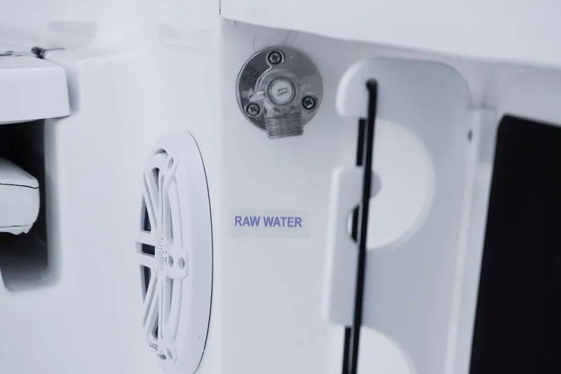 Slide: The Image of 2026 Tidewater 2110 Bay Max boat detail showing raw water access and speaker. - 15