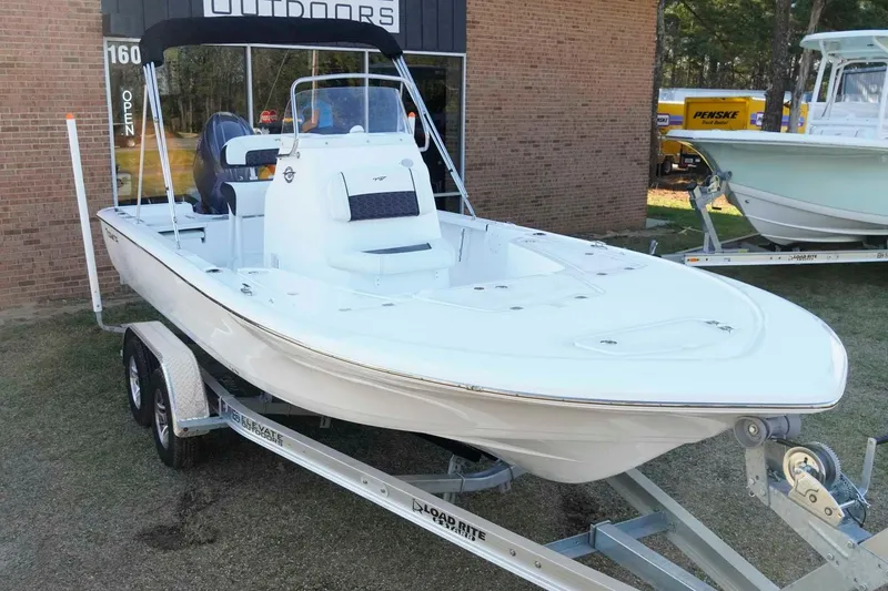 Slide: The Image of 2026 Tidewater 2110 Bay Max boat on trailer, displayed outdoors. - 2