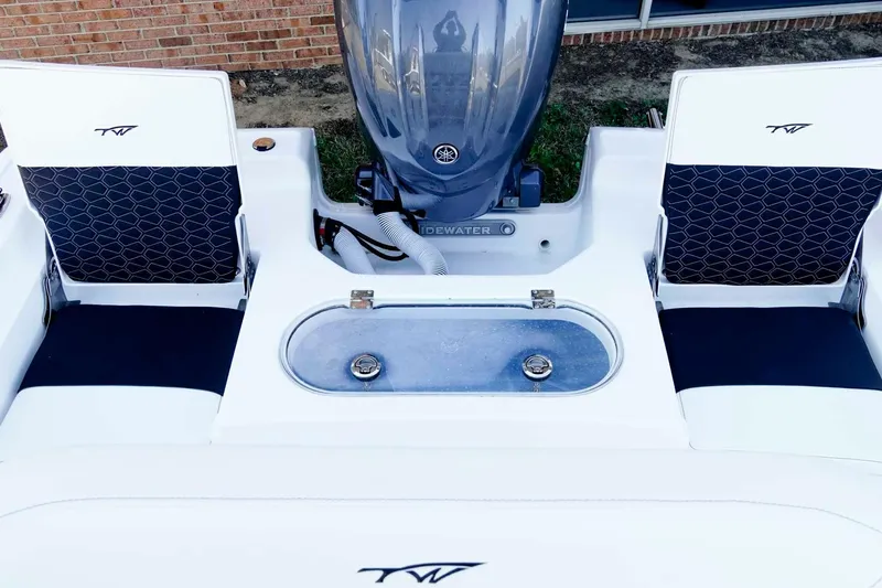 Slide: The Image of 2026 Tidewater 2110 Bay Max boat interior with seating and motor, showcasing modern design. - 20