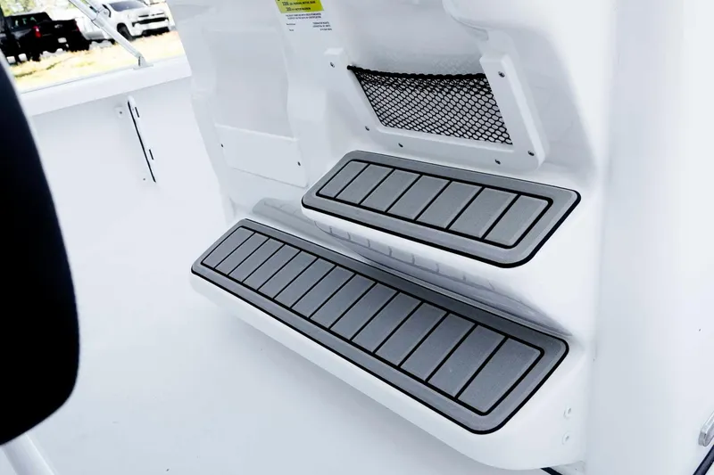 Slide: The Image of 2026 Tidewater 2110 Bay Max boat interior with non-slip steps and storage net. - 21