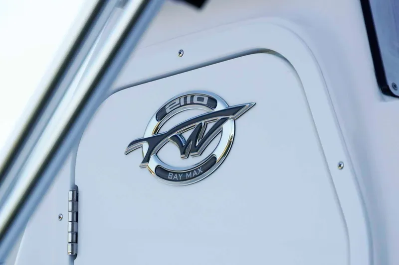 Slide: The Image of 2026 Tidewater 2110 Bay Max logo on a sleek white boat surface. - 3