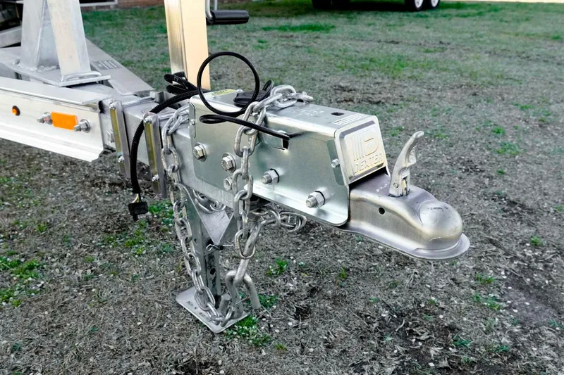 Slide: The Image of Trailer hitch of 2026 Tidewater 2110 Bay Max boat on grassy ground. - 35