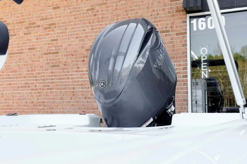 Slide: The Image of 2026 Tidewater 2110 Bay Max boat with Yamaha outboard motor, brick wall background. - 43