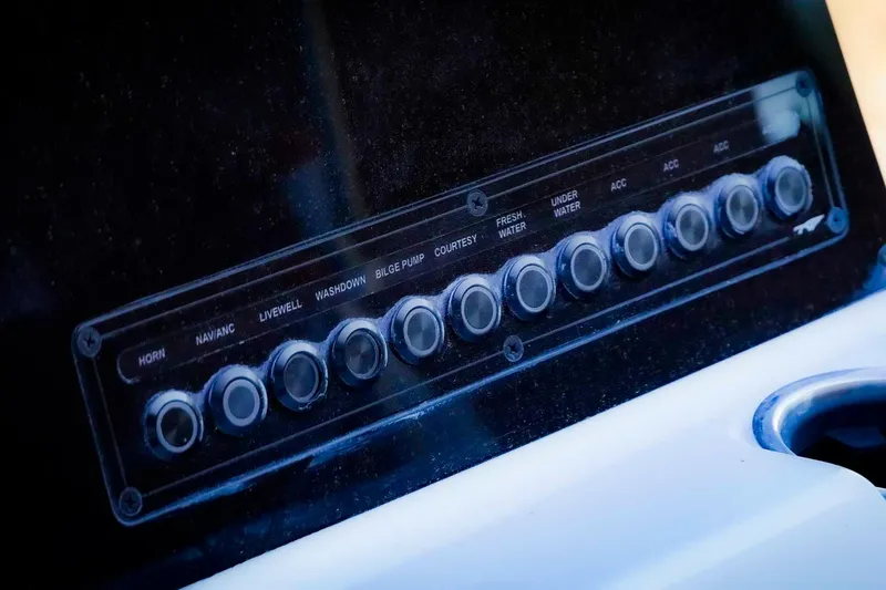 Slide: The Image of Control panel of 2026 Tidewater 2110 Bay Max boat with labeled switches. - 6