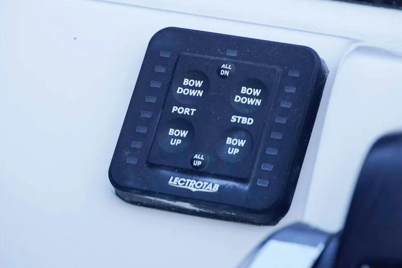 Slide: The Image of Control panel of 2026 Tidewater 2110 Bay Max boat with Lectrotab trim tab switches. - 8