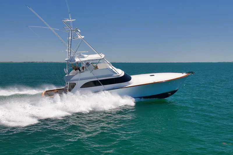 Slide: The Image of 2003 Weaver Custom Sportfish yacht cruising swiftly on open blue waters. - 11