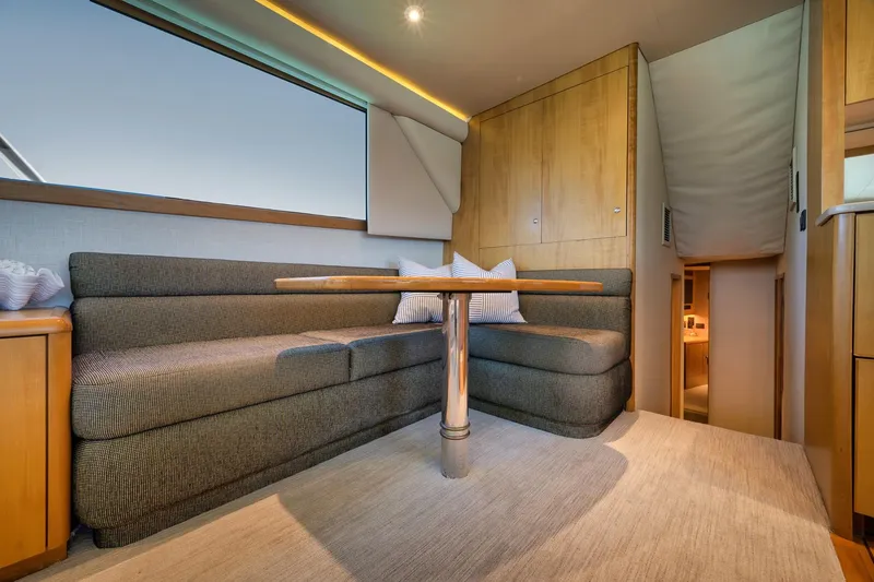 Slide: The Image of Interior of 2003 Weaver Custom Sportfish yacht with cozy seating and wooden accents. - 17