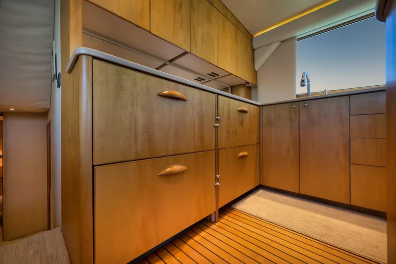 Slide: The Image of Luxurious wooden cabinetry in 2003 Weaver Custom Sportfish yacht kitchen interior. - 18