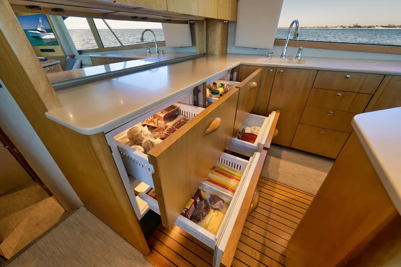 Slide: The Image of Luxurious 2003 Weaver Custom Sportfish yacht kitchen with open drawers and ocean view. - 19