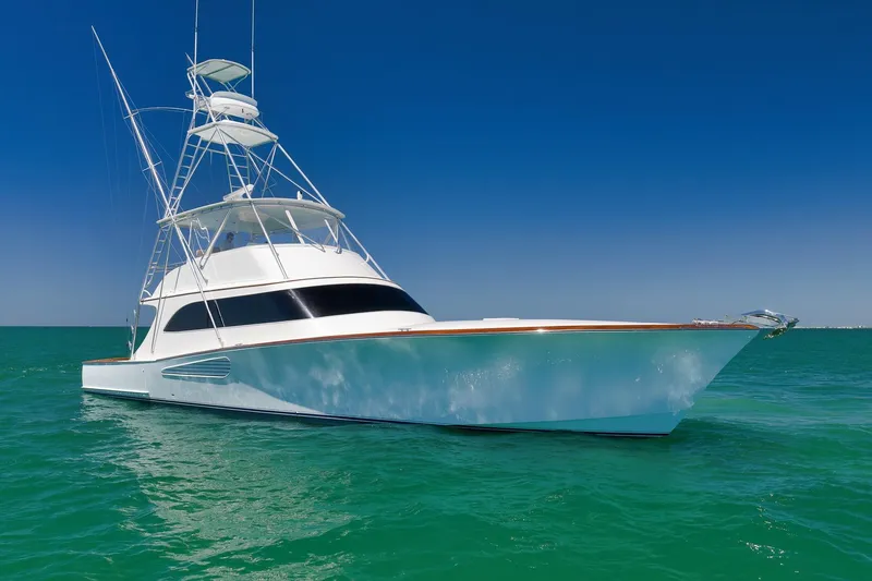 Slide: The Image of 2003 Weaver Custom Sportfish yacht on clear turquoise water under a bright blue sky. - 2
