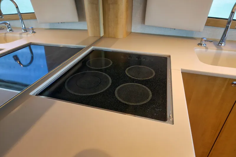 Slide: The Image of Modern kitchen in 2003 Weaver Custom Sportfish yacht with electric stovetop and sink. - 21