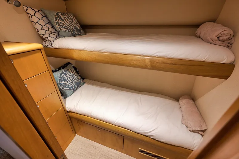 Slide: The Image of Cozy bunk beds in 2003 Weaver Custom Sportfish cabin with decorative pillows. - 23