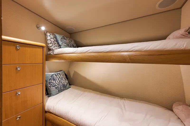 Slide: The Image of Cozy bunk beds in 2003 Weaver Custom Sportfish yacht cabin with wooden drawers. - 24