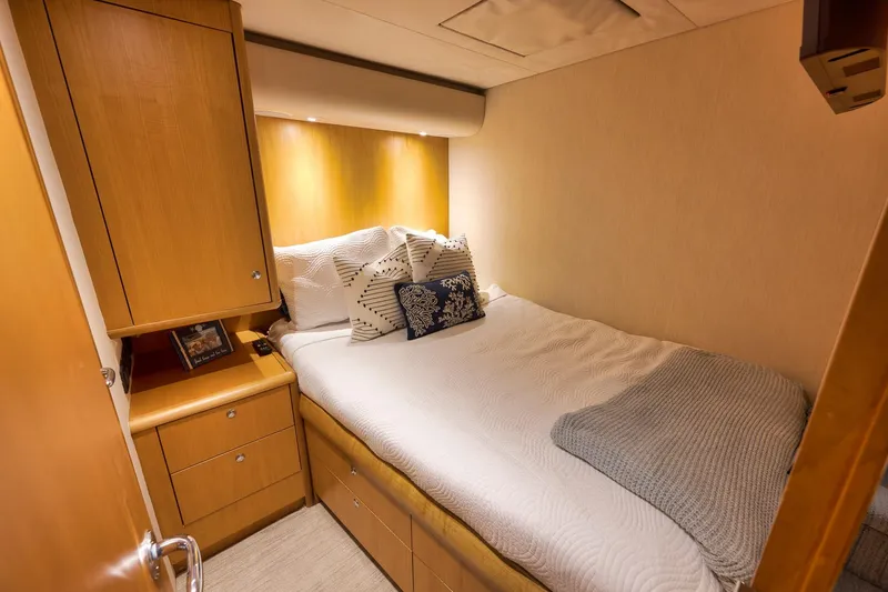 Slide: The Image of Cozy bedroom in 2003 Weaver Custom Sportfish yacht with wooden cabinetry and soft lighting. - 26