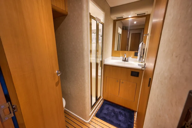 Slide: The Image of Luxurious bathroom interior of 2003 Weaver Custom Sportfish yacht with wooden cabinetry and modern fixtures. - 27