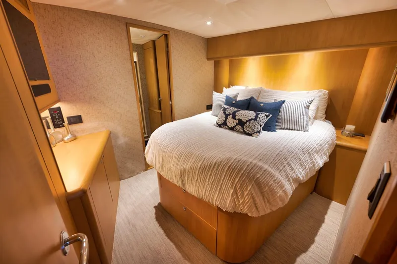 Slide: The Image of Luxurious bedroom interior on 2003 Weaver Custom Sportfish yacht with cozy bedding and wooden accents. - 29