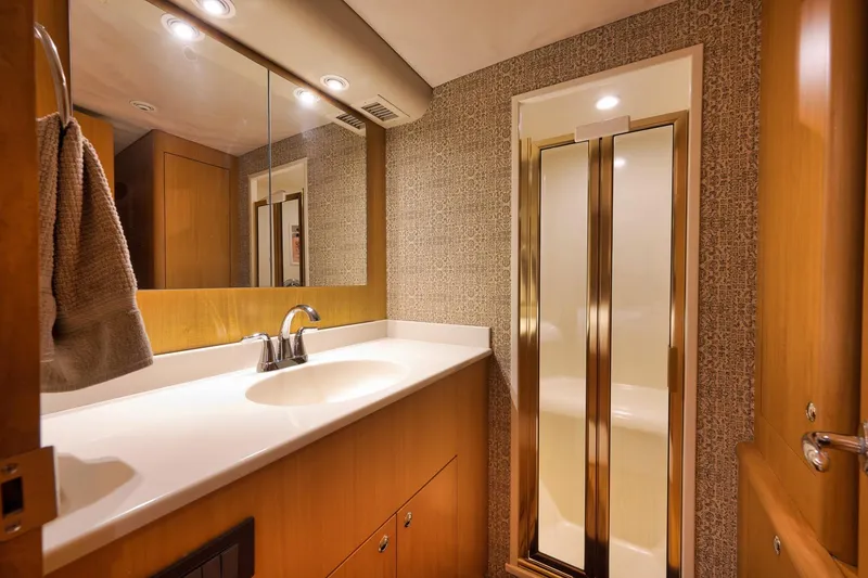 Slide: The Image of Luxurious bathroom interior on a 2003 Weaver Custom Sportfish yacht, featuring elegant fixtures and lighting. - 31