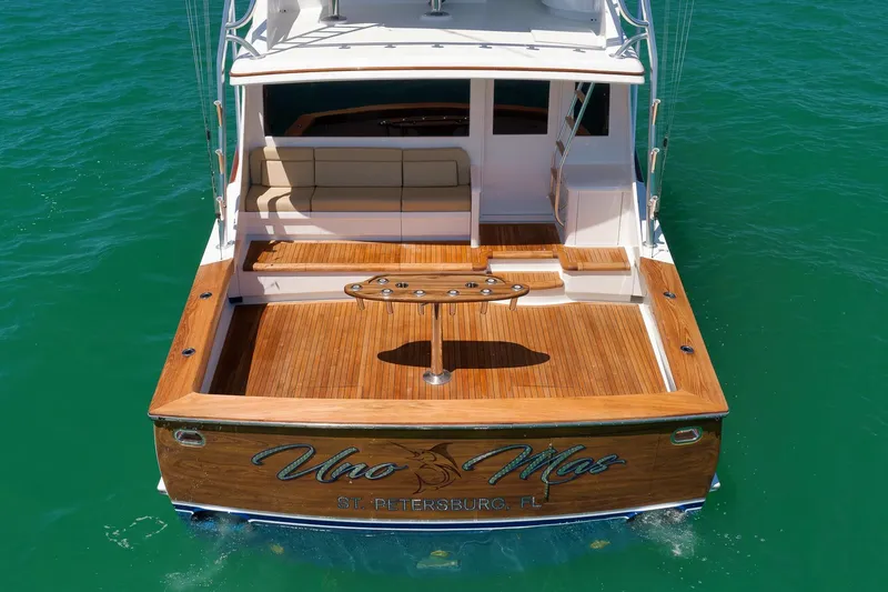 Slide: The Image of 2003 Weaver Custom Sportfish boat with wooden deck, docked in clear water. - 33